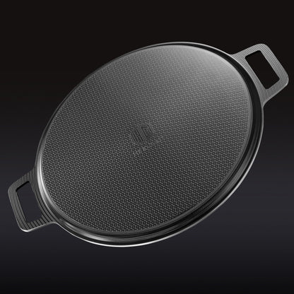 The underside of the HexClad hybrid pizza steel on a black background