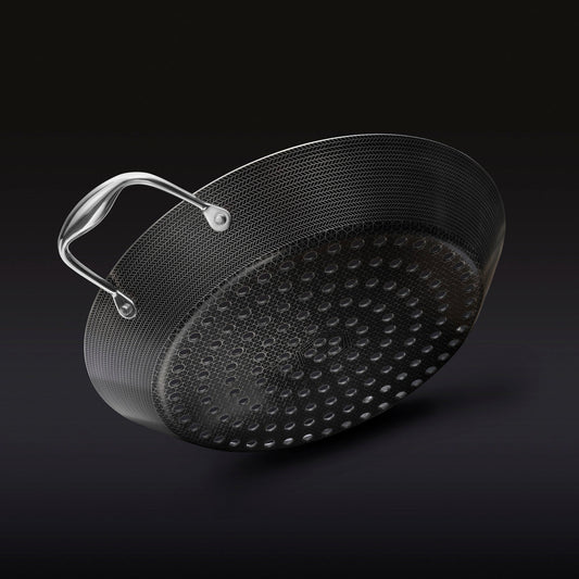 The underside of the HexClad 12&quot Hybrid BBQ Grill Pan on a black background